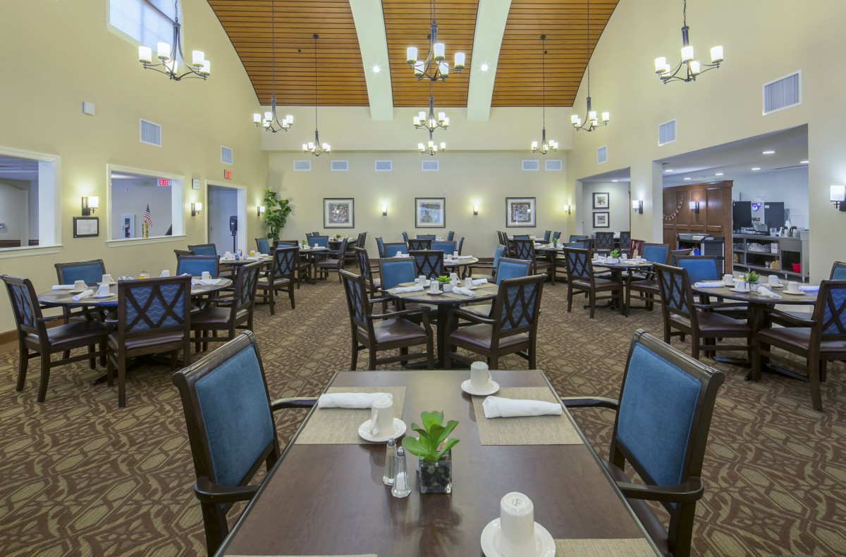 Spacious dining area with neatly arranged tables and elegant lighting.