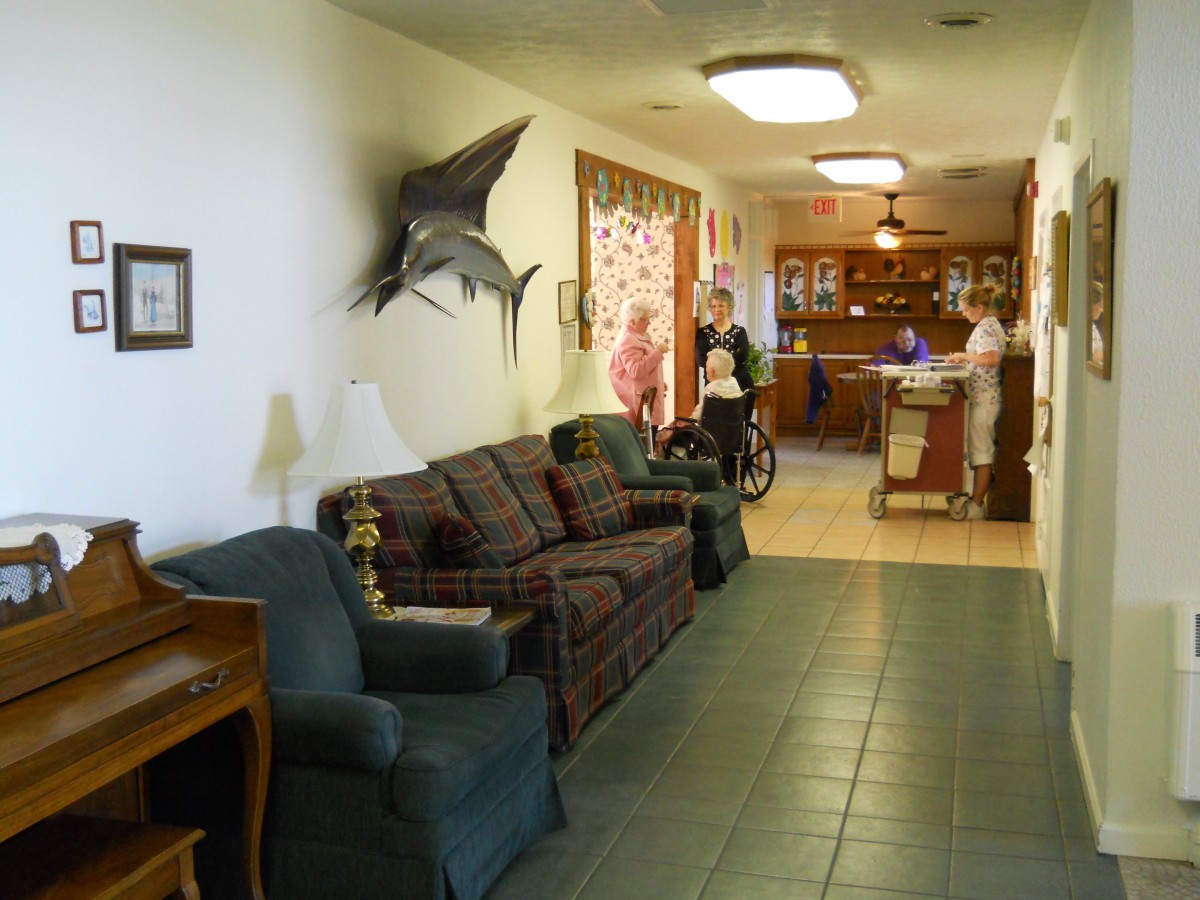 A cozy waiting area with seating and a reception desk in the background.