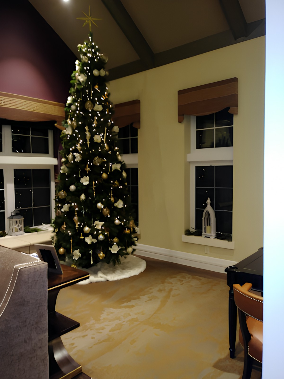 A cozy living room adorned with a beautifully decorated Christmas tree.