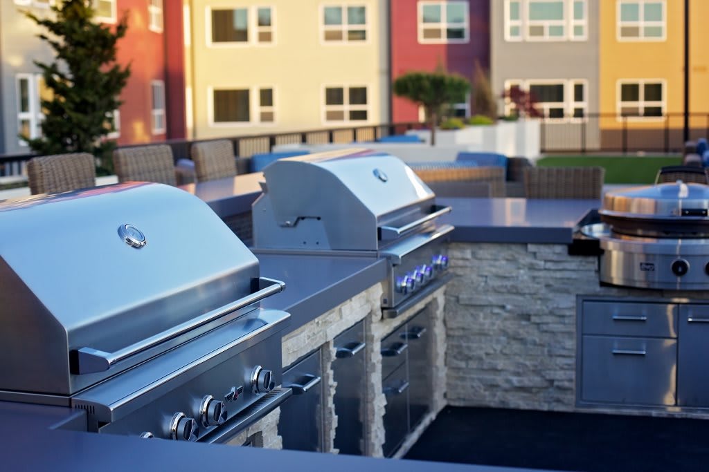 Modern outdoor grilling area in an apartment complex.