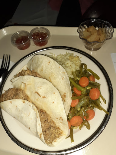 A hearty dinner featuring tacos, rice, and a side of mixed vegetables.