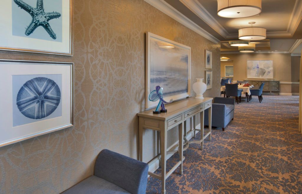 A well-decorated hallway with art and modern furnishings.