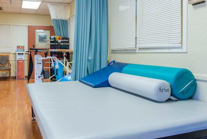 A rehabilitation clinic with exercise equipment and treatment area.