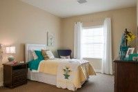 A cozy bedroom with elegant decor and natural lighting.