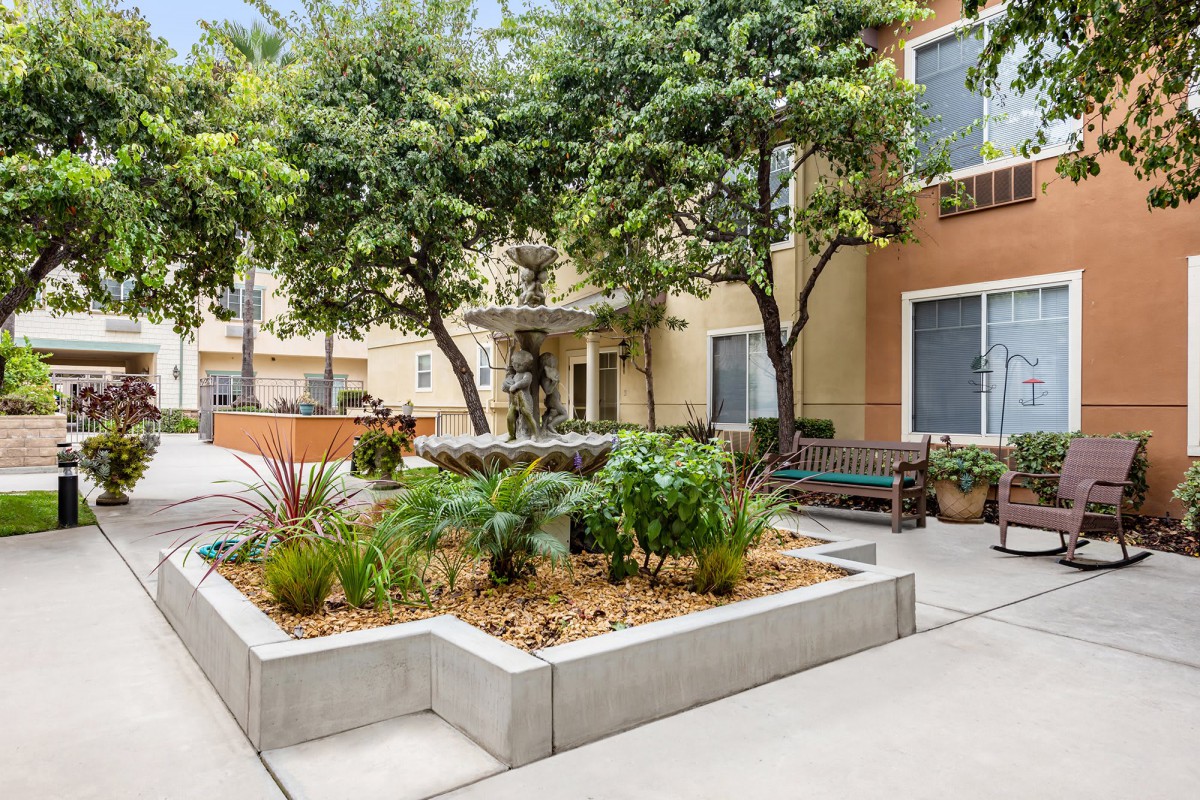 A well-maintained courtyard with lush greenery and seating.