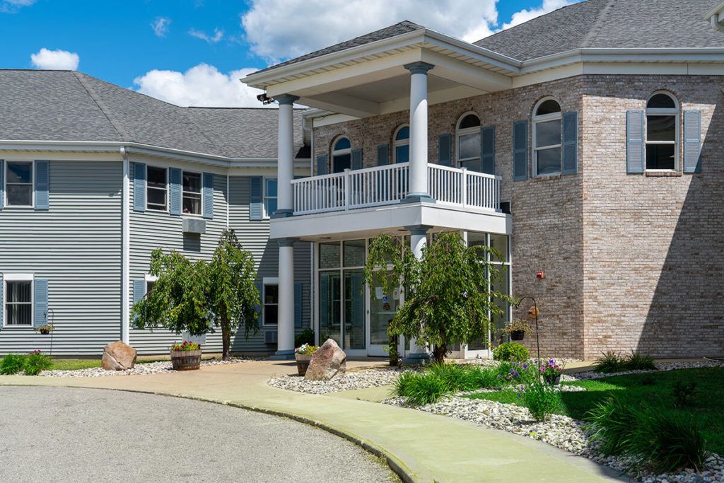A modern house with a grand entrance and landscaped surroundings.