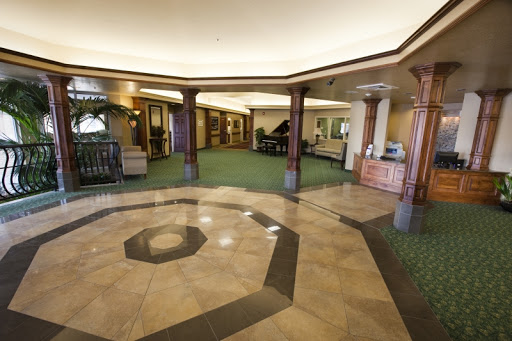 A spacious and elegantly designed lobby featuring polished flooring and welcoming decor.