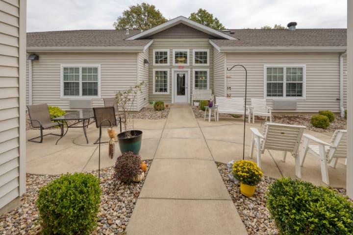 A well-maintained house with a front patio and garden pathway.