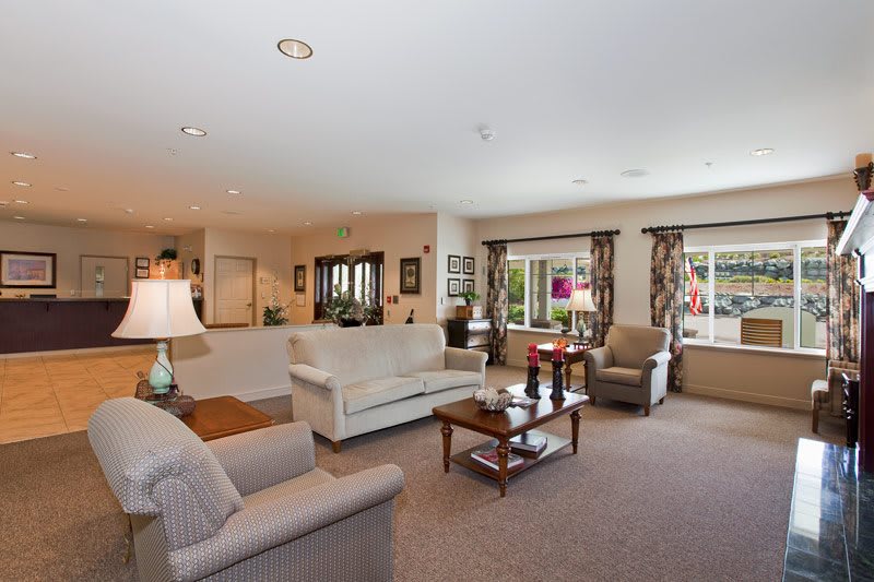 A spacious and well-decorated living room with comfortable seating and natural light.