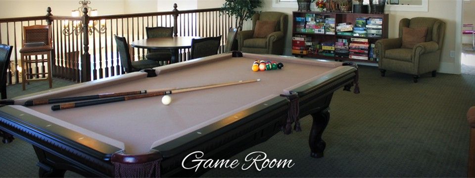 A cozy game room featuring a pool table and seating area.