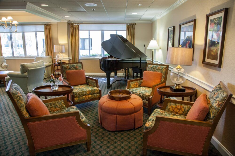 A cozy living room featuring a grand piano and comfortable seating.