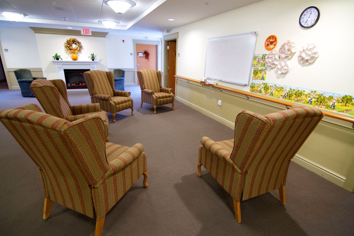An inviting meeting room with arranged chairs and a whiteboard ready for a session.