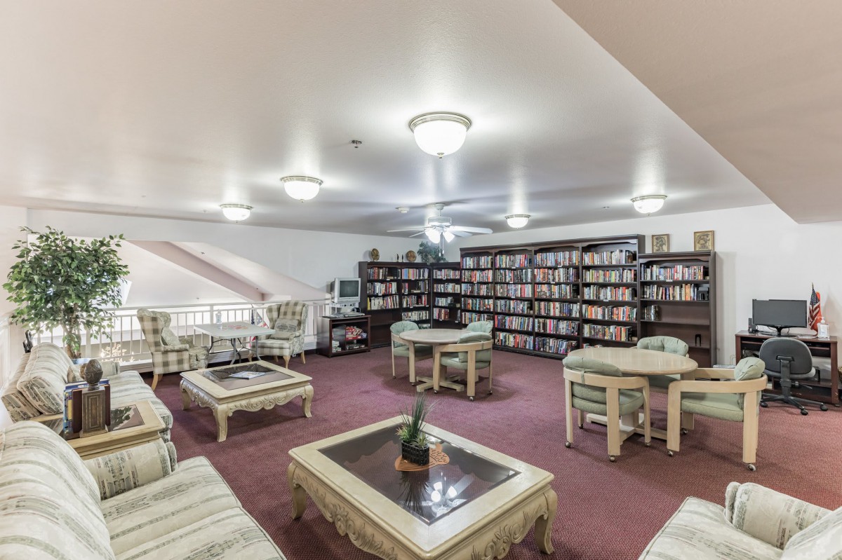 A cozy library with bookshelves and a comfortable reading area.
