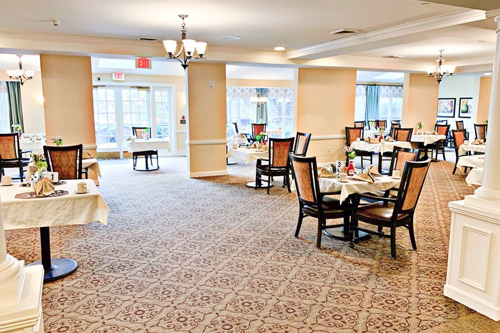 A spacious dining area with elegantly set tables and ample natural light.