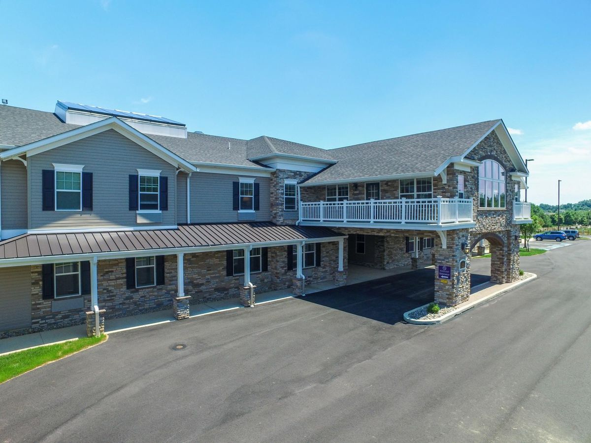 A two-story commercial building with a modern design and ample parking space.