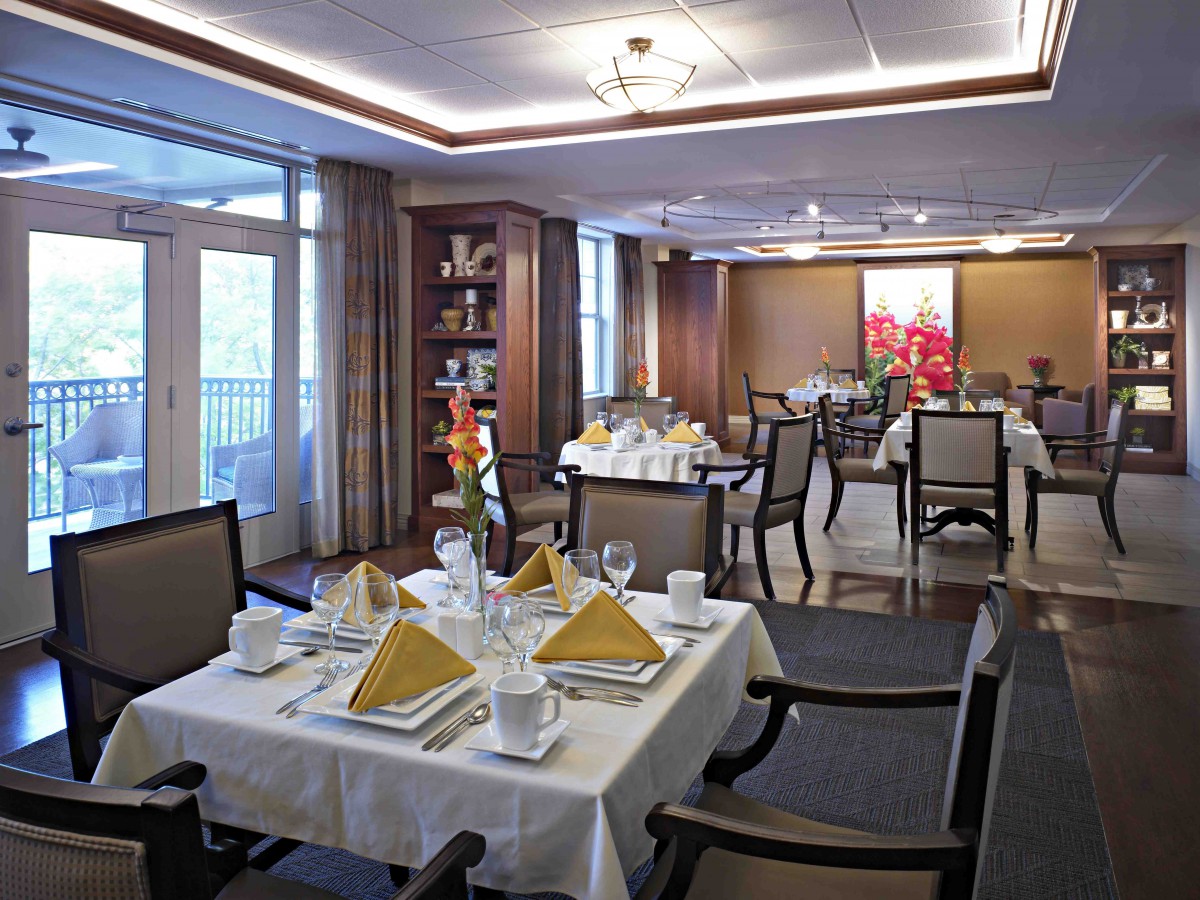 An elegantly set dining room with neatly arranged tables and sophisticated decor.