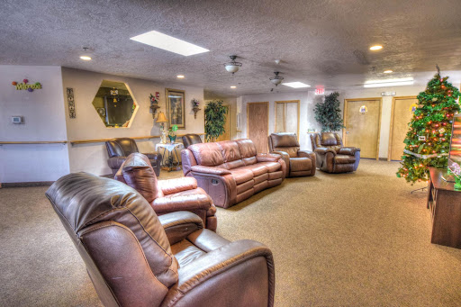 A cozy living room setup featuring comfortable leather sofas and chairs, designed for relaxation.