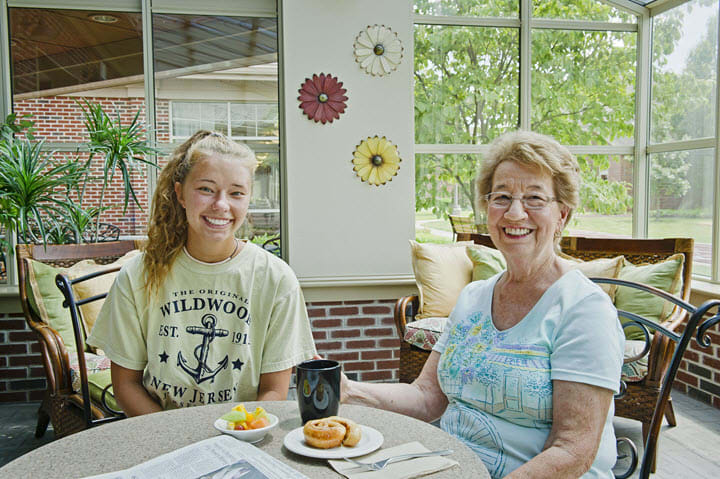 Two people enjoying a pleasant breakfast together in a bright indoor setting.