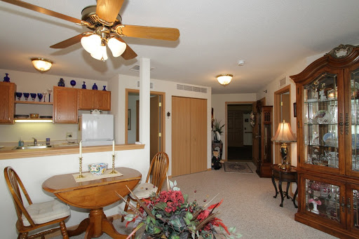 A cozy living room featuring a ceiling fan and elegant decor.