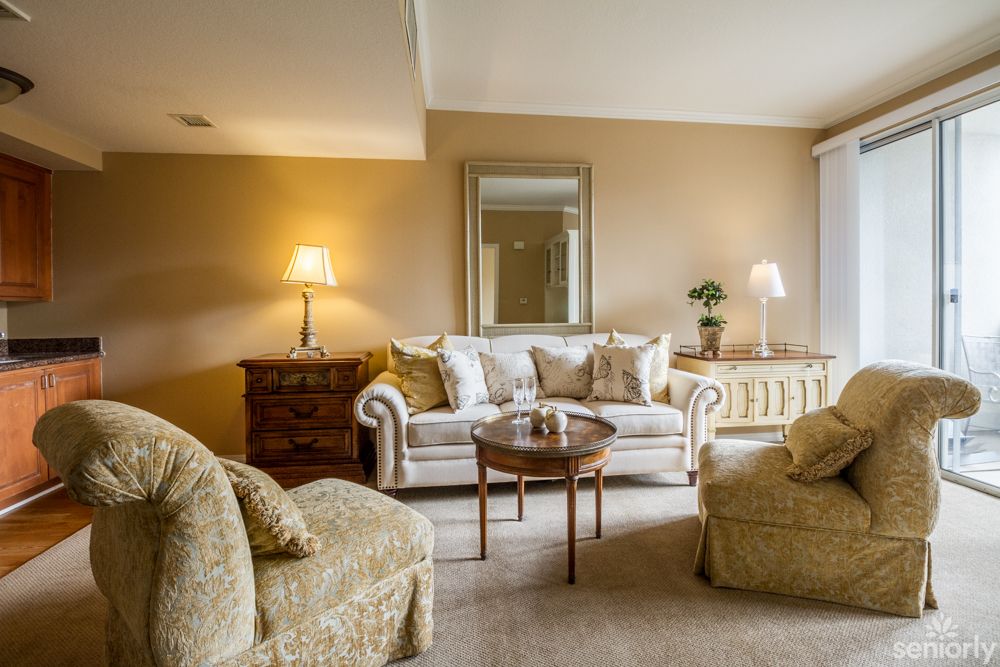 A cozy living room with elegant furniture and warm lighting.