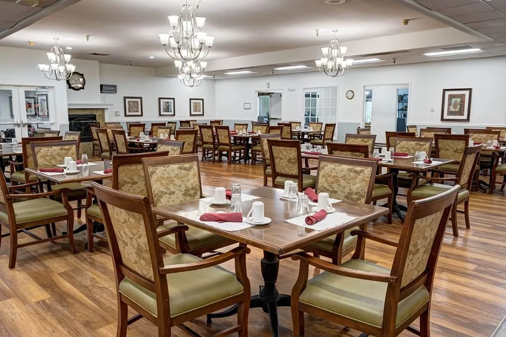 An empty dining room with neatly set tables and chairs.