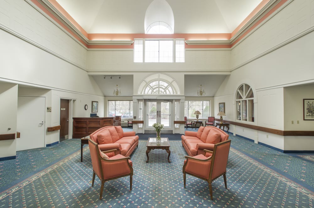 A spacious lobby with comfortable seating and large windows allowing natural light to fill the room.