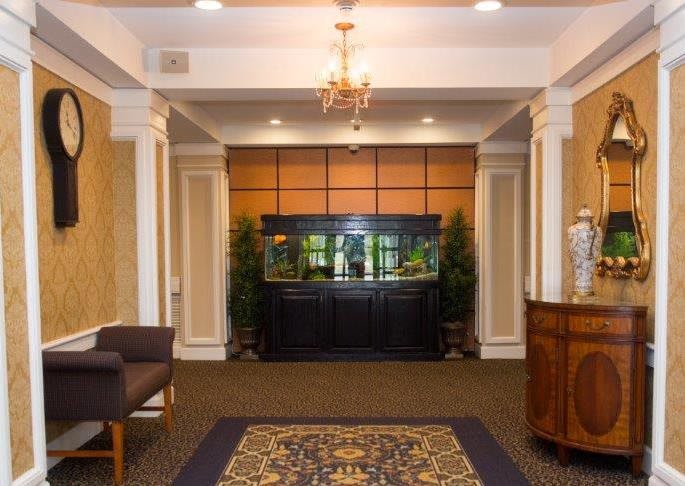 A well-decorated lobby featuring an aquarium and elegant furnishings.