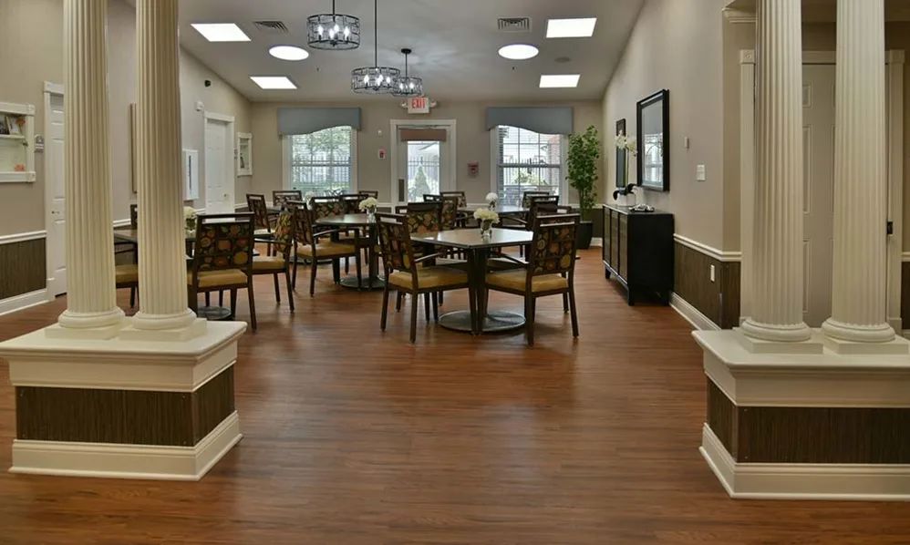 A spacious dining area with elegant decor and wooden flooring.