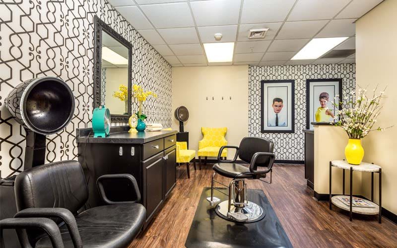 Modern hair salon interior with stylish decor and comfortable seating.