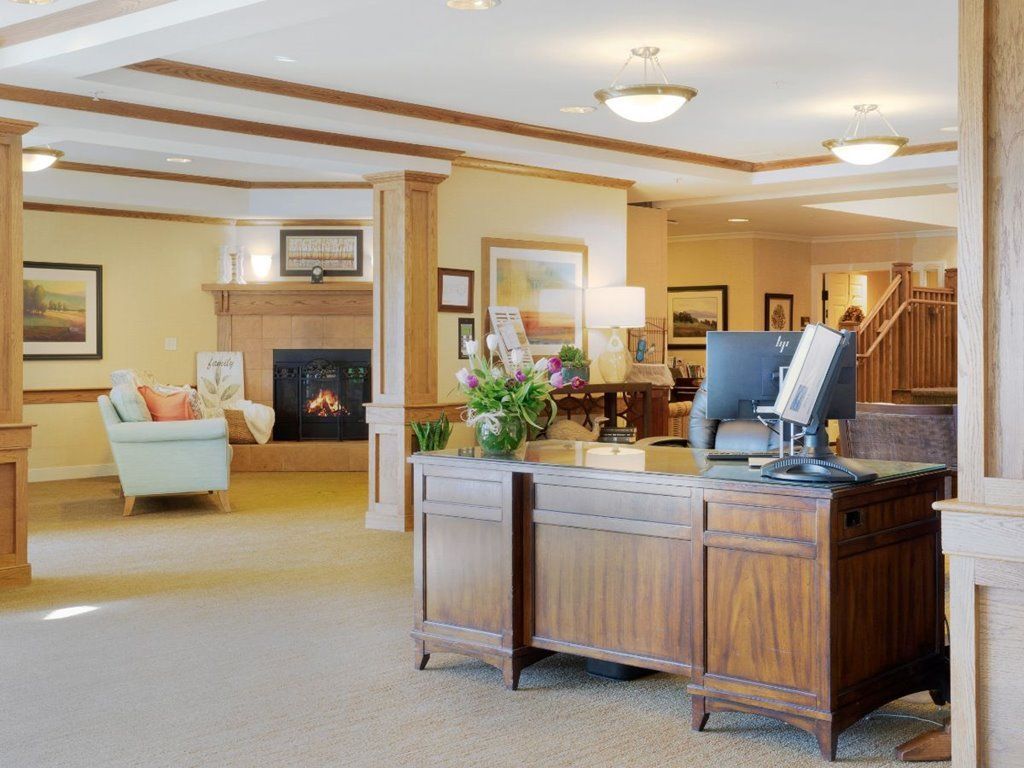 Elegant reception area with a wooden desk and comfortable seating.
