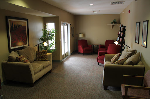 A cozy living room featuring comfortable seating and natural light.