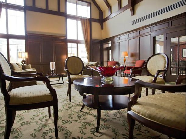 A luxurious living room with elegant furniture and classic wood paneling.