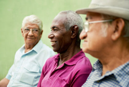 A group of elderly men enjoying a conversation together.