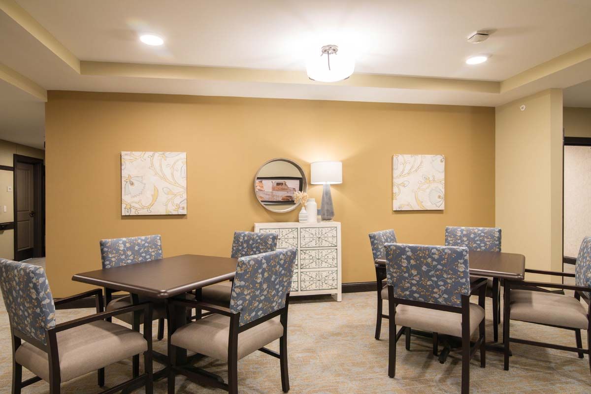A modern dining room with stylish furniture and decorative artwork on the walls.
