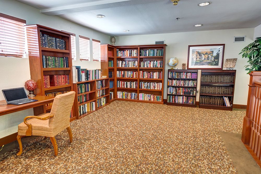 A quiet library corner with bookshelves and a comfortable chair.