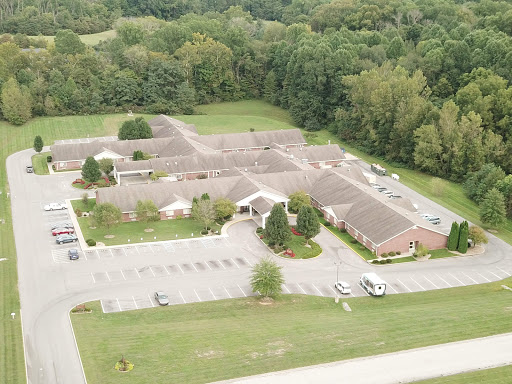 An aerial view of a residential complex surrounded by lush greenery.
