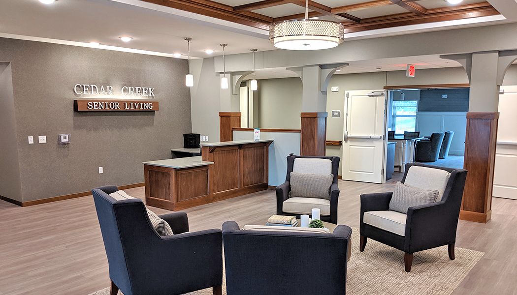 A modern lobby with comfortable seating and a reception desk.