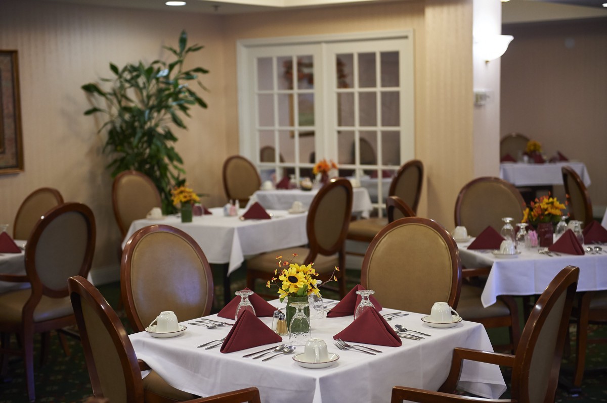 A cozy dining room with neatly set tables and elegant decor.