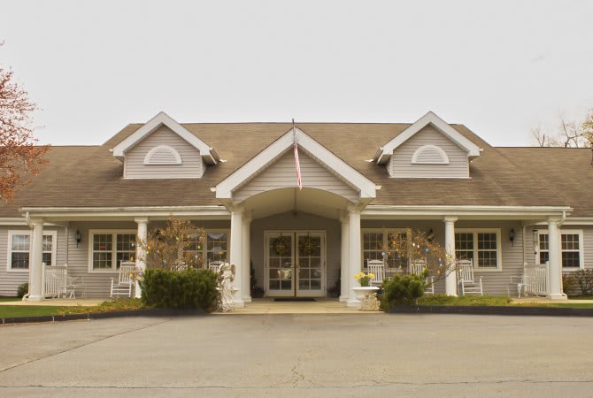 A symmetrical building with a central entrance and prominent columns.