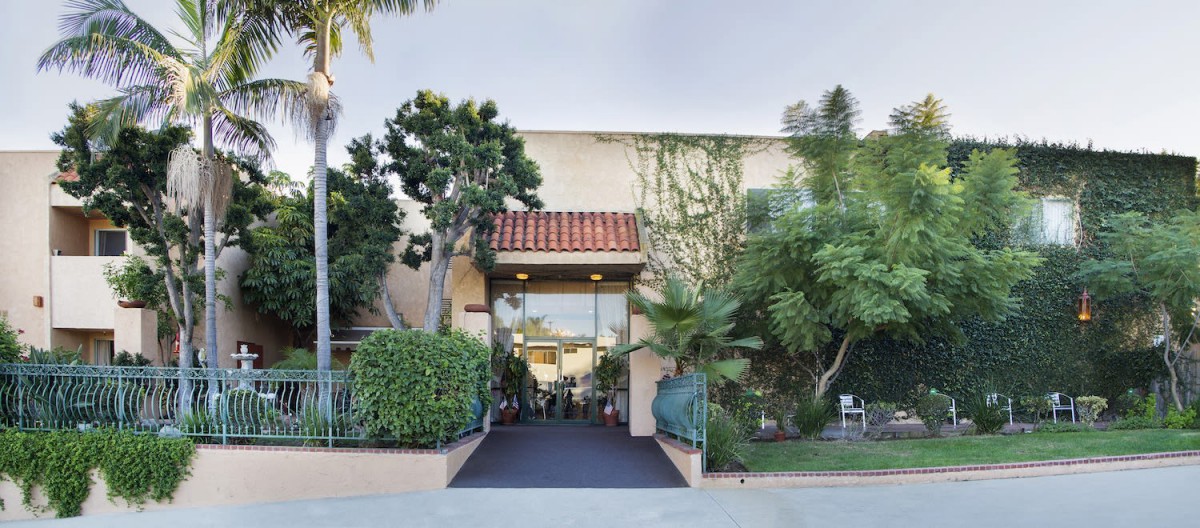Entrance to a building surrounded by lush greenery.