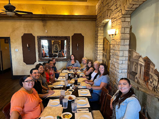 A joyful gathering of friends enjoying a meal together at a restaurant.
