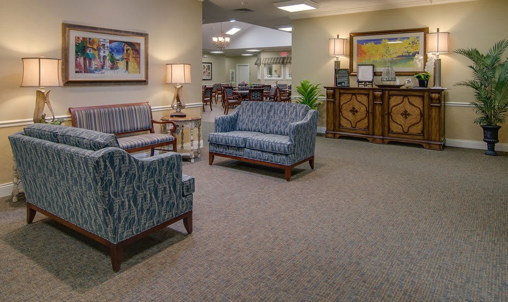 An inviting reception area with comfortable seating and artwork on the walls.