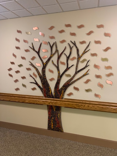 A beautifully crafted tree mural with branches and leaves, adding a touch of nature to the wall.