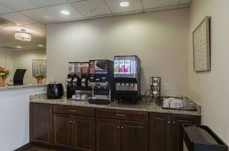 A well-equipped coffee and beverage station in a hospitality setting.