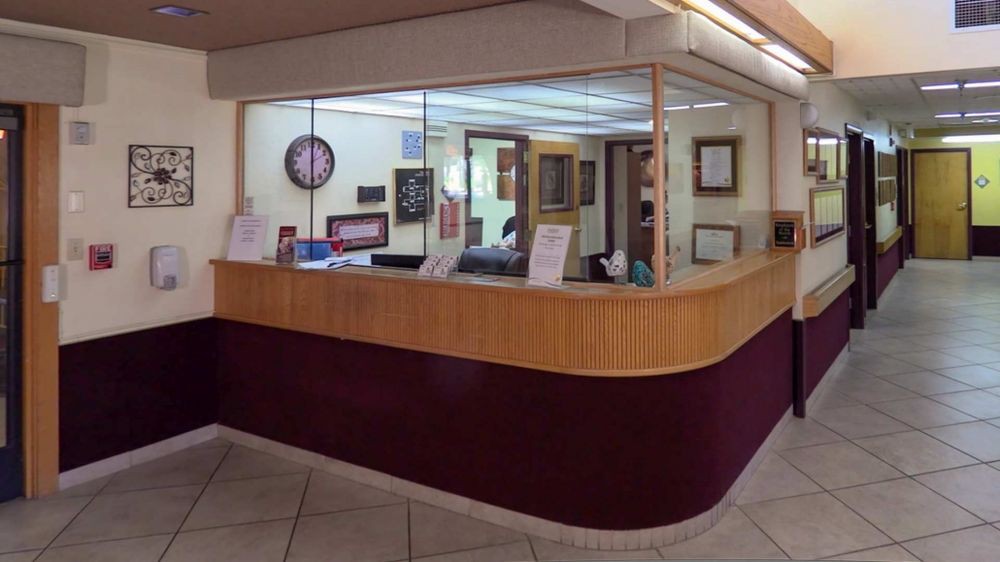 A view of an office reception desk surrounded by glass walls.