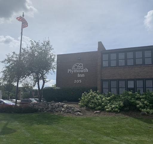 Exterior view of a school building with signage and a flag.