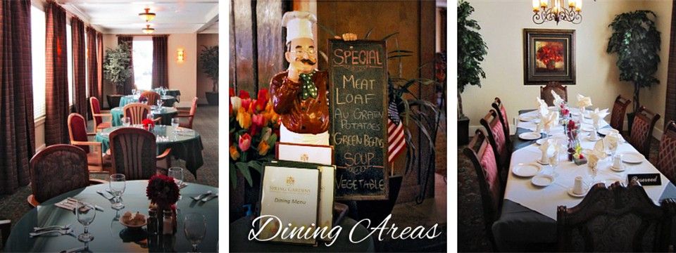 A cozy dining area featuring a specials menu board with a chef statue and decorative flowers.