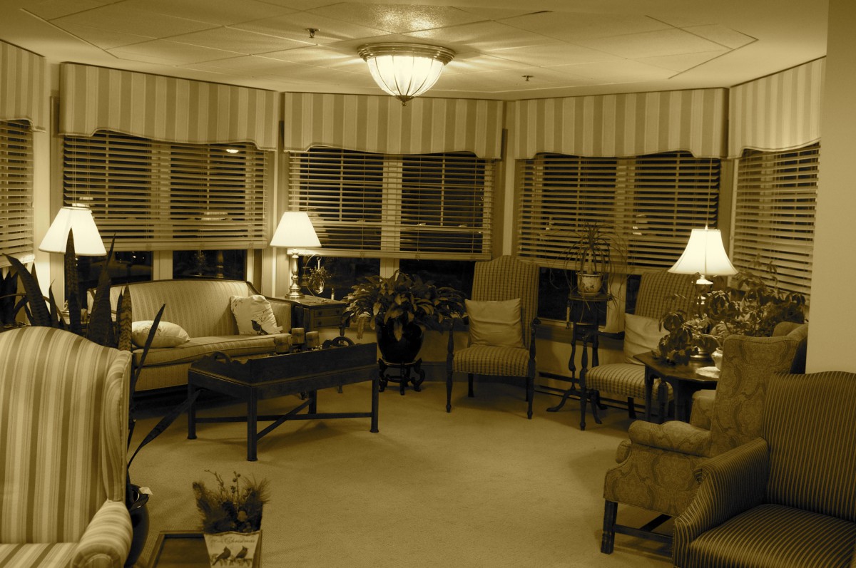 A cozy living room with elegant furniture, soft lighting from lamps, and a comfortable atmosphere.