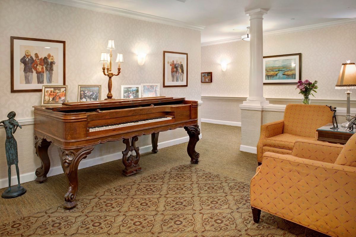 A cozy living room featuring a classic piano and elegant decor.