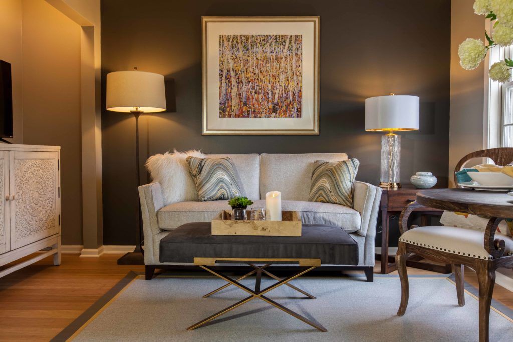 A stylish living room with a cozy sofa, modern coffee table, and elegant lighting.
